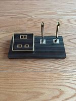 Full view of the vintage striped desk set with calendar and dual pens on a wooden surface.