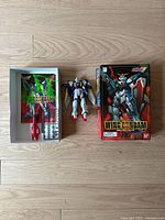 Wing Gundam action figure, box, cargo tray with accessories, and instruction manual displayed on wooden floor