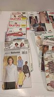 Group of pattern envelopes showing Burda 6114, Burda 5695, Butterick B4347 and others