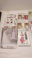 Front view of multiple pattern envelopes including Vogue Vera Wang bridal pattern, several McCall’s patterns and Advance/See & Sew