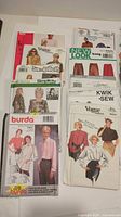Assorted Vogue, Simplicity, New Look, Kwik•Sew and Burda patterns displayed on table