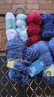Top view of multiple skeins showing colours white, mint, red, navy, denim with labels