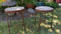 Both round rustic tables outdoors showing overall condition