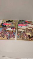 Four Giles cartoon books laid out, covers partially visible
