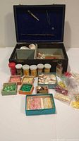 Lot overview with open box, containers of shells and accessories