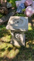 Full view of square concrete pedestal stand outdoors