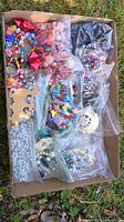 Overall view of box with multiple bags of beads and findings