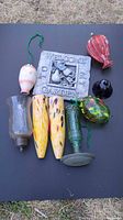 All items laid out showing variety of glass ornaments, feeder pieces, plaque, shades