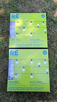 Two sealed boxes Room Essentials string lights on grass