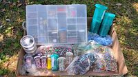 Full lot overview showing organizer, tubes, vials and bags of beads in cardboard box