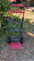 Front view of Milwaukee hand truck showing frame, handle, toe plate and wheels