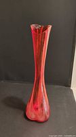 Full front view of tall orange-red Norcrest glass vase