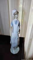 Front-facing photo of the porcelain nurse figurine showing full body, light blue dress, white apron, and cap.