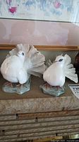 Pair of white Rosenthal bird figurines side by side showing full view.