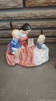Front view of Royal Doulton Bedtime Story figurine showing seated woman reading to two children.