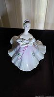 Front view of the Royal Doulton ballerina figurine in a pink and white dress with floral details.