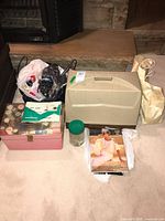 Full overview of lot contents including sewing machine case, thread spools in pink box, yarn bags, and pattern booklet
