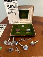 Overview of all sterling silver cufflinks and tie pins, including original display box with green velvet lining and cream silk interior showing "Sterling Silver" text.