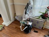 Full view of Rowenta garment steamer, ironing board in background