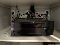 Front view of the Yamaha RX-V1900 AV receiver showing power and input knobs, Yamaha branding and model info.