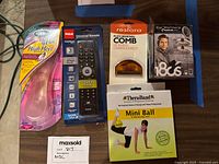 Overview of all items in the lot: ear warmers, mini ball, fuzz comb, remote, insoles