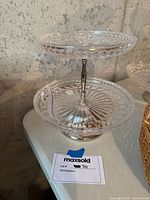 Two-tier glass serving stand showing pressed glass detailing, silver metal post, missing top connector.