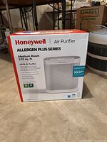 Front view of Honeywell Allergen Plus Series air purifier box showing product image, branding, and key features for medium rooms 155 sq. ft.