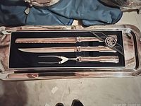 Photo of Tower 3-piece carving set in black storage box with three utensils visible on silver tray (tray not included)