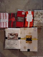 All the linens visible including napkins and tablecloths from various brands with packaging and tags visible