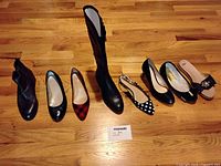 Photo showing 8 pairs of women's size 7 shoes including ankle boots, knee boots, flats, slip-ons and slingbacks with varied patterns and styles.