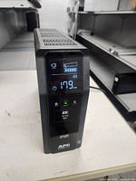 Front view of APC Back-UPS Pro 1500 S showing LCD display with battery charge and output voltage