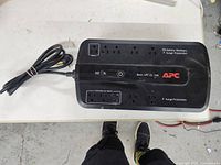 Top view of APC Back-UPS ES 750 showing 8 outlets and power button.