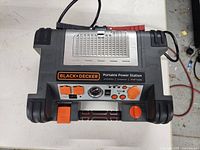 Top view of Black & Decker Portable Power Station showing control panel with power dial, air pressure gauge, power supply outlets, and connection ports.