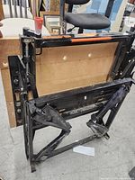 Full folded view of the Black and Decker Workmate 550 portable project center showing metal frame and wooden top panel.