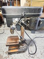 Side view of the drill press showing the motor and lever handle