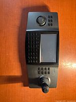 Full view of the Hikvision keyboard controller showing the screen, joystick, numeric keys and control buttons.