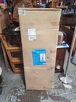 Full view of the sealed cardboard box showing label with product info.