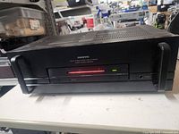 Front view of Onkyo M-5180 stereo power amplifier with red LED lit, black finish, and minimal front controls.