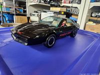 Front three-quarter view of black KITT car on blue surface