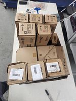 Box containing multiple Xerox toner cartridge boxes in black and brown cardboard packaging.