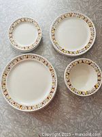 Stacked sets of dinner, lunch, side plates and bowl showing pattern