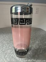 Full view of glass shaker showing graphics and chrome lid