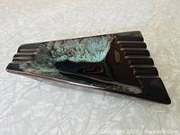 Top view of triangular ceramic ashtray showing drip-glaze interior