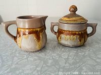 Creamer and lidded sugar bowl front view