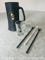 Group shot showing stein, shot glass, and three swizzle sticks