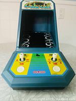 Front view of Coleco Galaxian mini arcade showing marquee, screen hood and overall unit