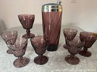 Cocktail shaker and seven goblets grouped together