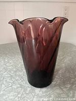 Side view of amethyst glass vase showing swirl pattern and overall form