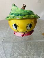 Front view of lemon head sugar bowl on clear stand