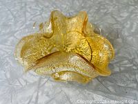 Top view showing ruffled rim and aventurine flecks